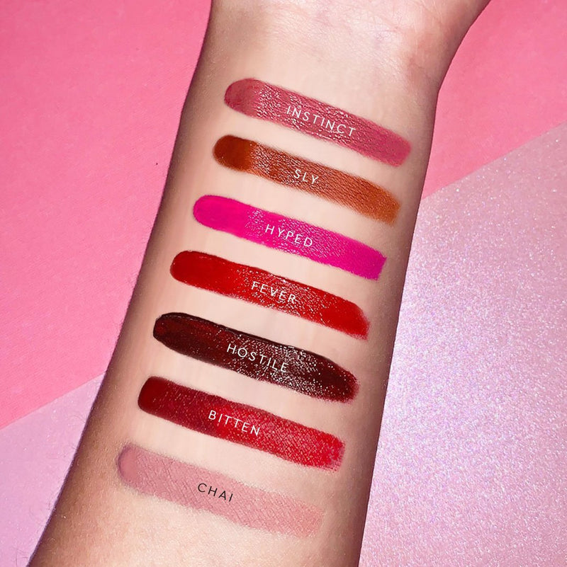 Matte Made in Heaven swatches on light skin. From top to bottom: Instinct, Sly, Hyped, Fever, Hostile, Bitten, and Chai. 